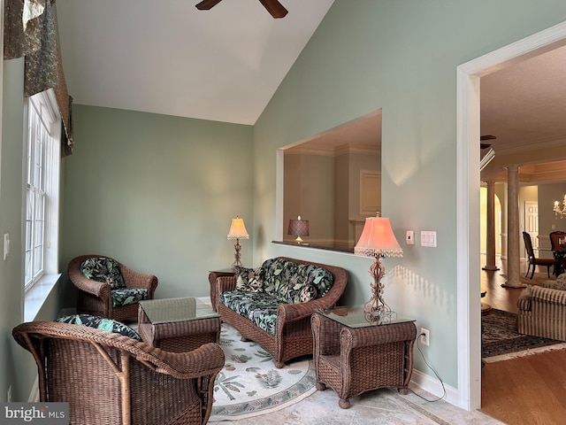 sitting room featuring ceiling fan, high vaulted ceiling, ornamental molding, light hardwood / wood-style floors, and ornate columns