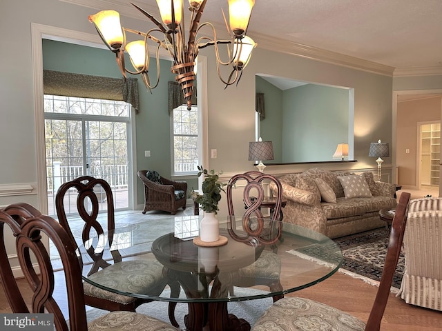 dining room with crown molding and a notable chandelier