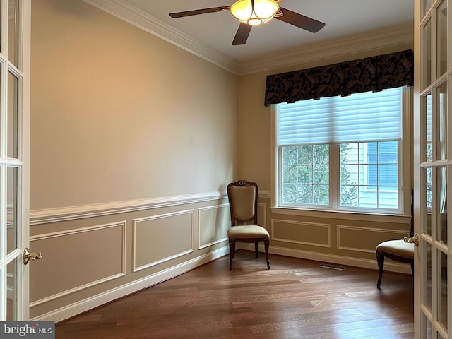 living area with crown molding, wood-type flooring, french doors, and ceiling fan