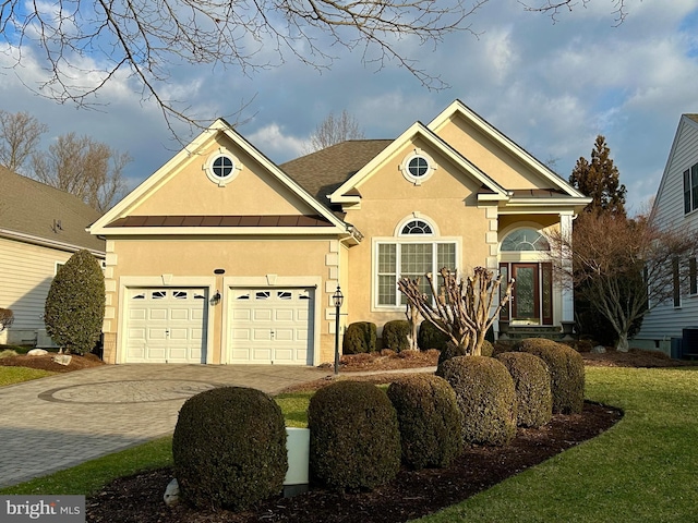 view of front of home featuring a garage and a front lawn