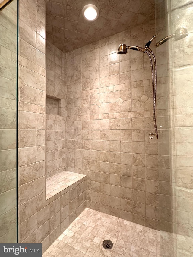 bathroom with tiled shower