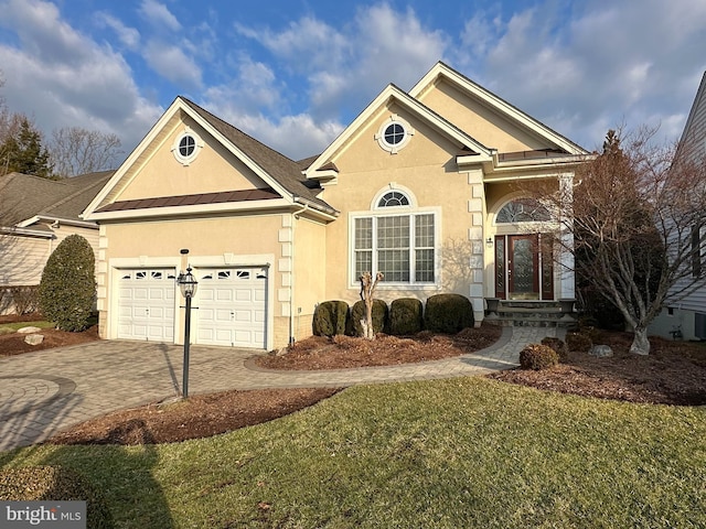 view of front of house with a garage and a front yard