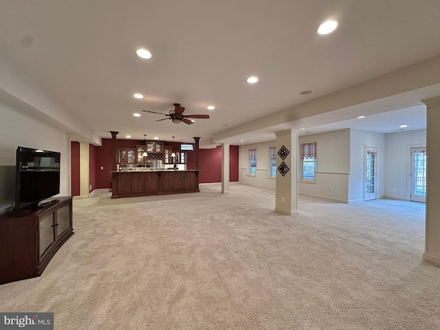 living room with light colored carpet and ceiling fan