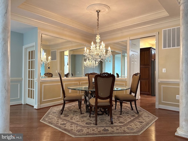 dining room featuring an inviting chandelier, ornamental molding, dark hardwood / wood-style flooring, and a tray ceiling