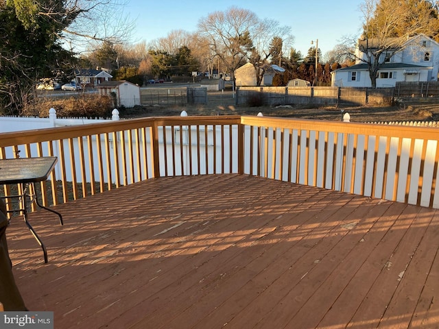 wooden deck with a fenced backyard and a residential view