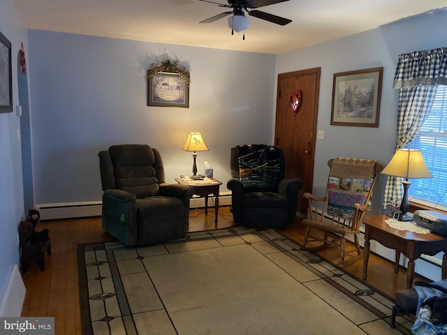 living area with hardwood / wood-style flooring, a baseboard radiator, and ceiling fan