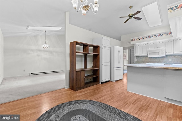 kitchen with white cabinetry, hanging light fixtures, white appliances, and a baseboard radiator