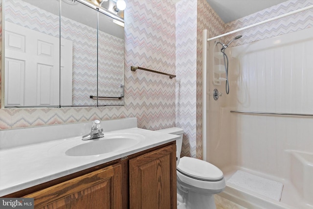 bathroom featuring vanity, toilet, and walk in shower