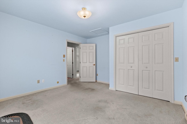 unfurnished bedroom featuring light colored carpet and a closet