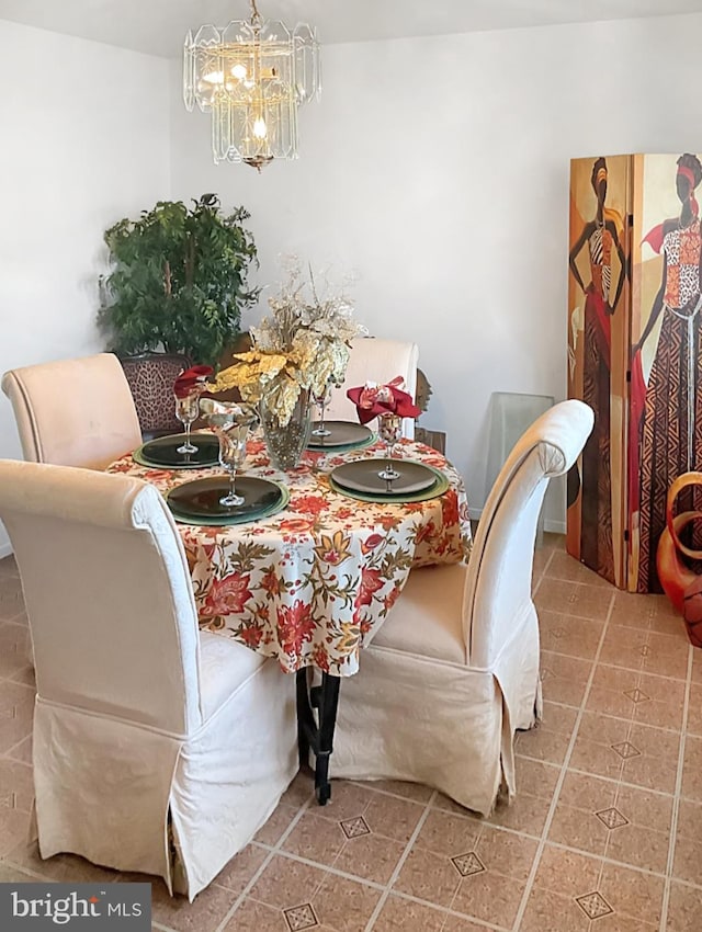 tiled dining area featuring an inviting chandelier