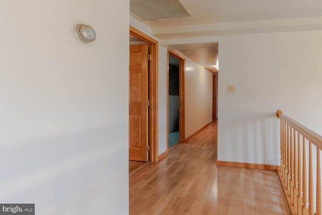 corridor with light hardwood / wood-style floors