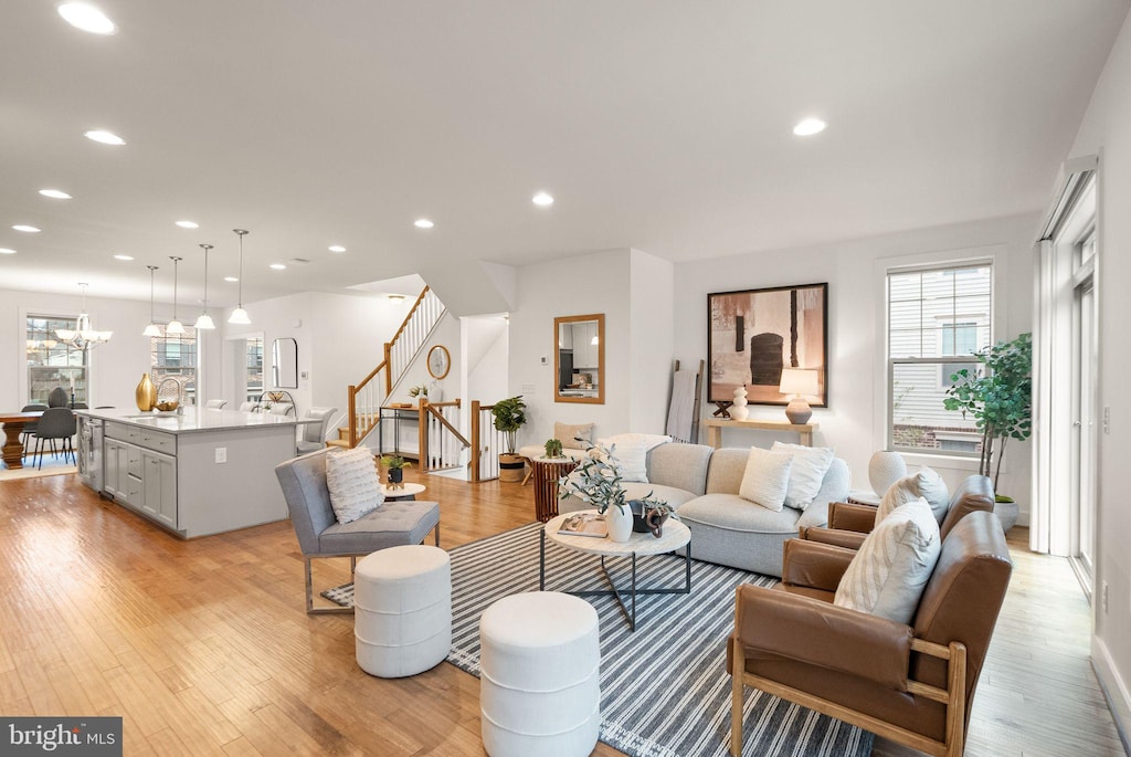 living room featuring light hardwood / wood-style floors and a chandelier