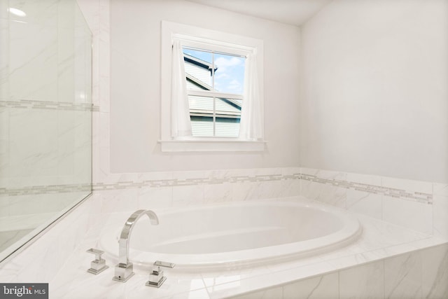 bathroom with tiled tub