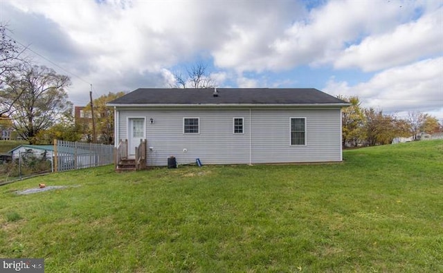 back of house featuring a yard