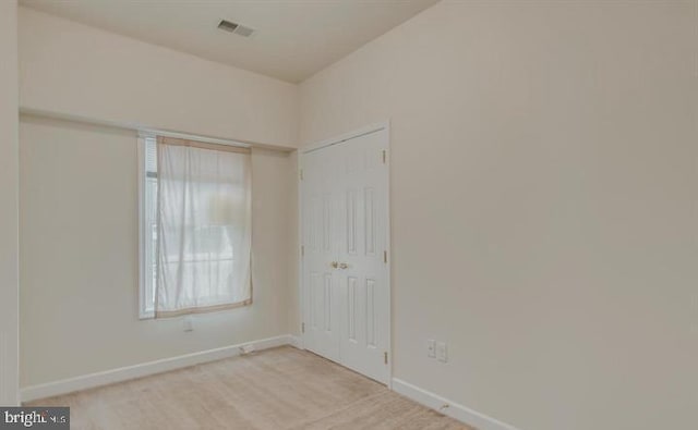 spare room featuring light colored carpet