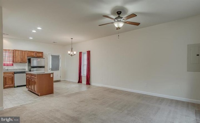 kitchen featuring decorative light fixtures, appliances with stainless steel finishes, electric panel, a kitchen island, and light colored carpet