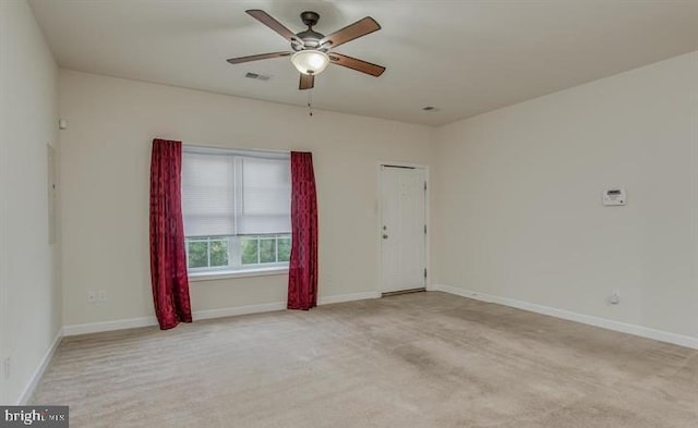 unfurnished room featuring light carpet and ceiling fan