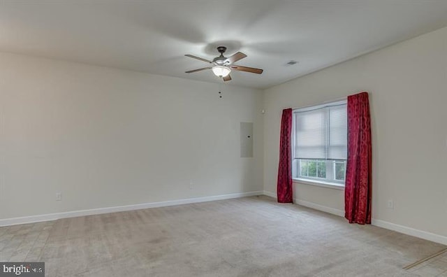 carpeted spare room featuring electric panel and ceiling fan