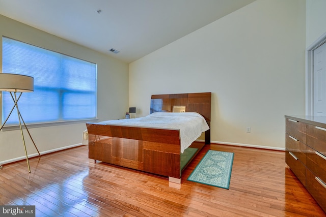 bedroom featuring vaulted ceiling and light hardwood / wood-style floors