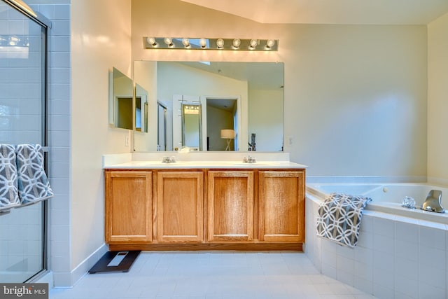 bathroom featuring tile patterned flooring, vanity, and shower with separate bathtub