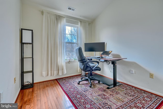 office area featuring wood-type flooring and vaulted ceiling