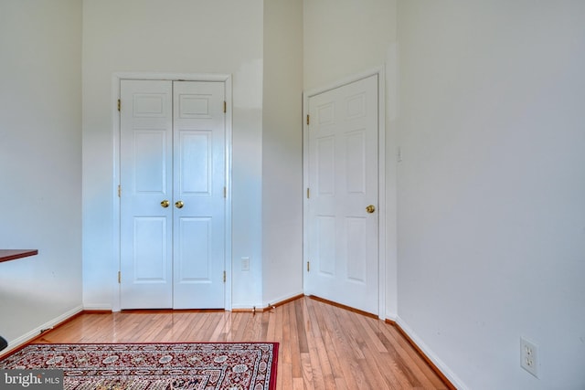 unfurnished bedroom with light hardwood / wood-style floors and a closet