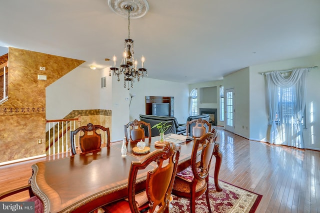 dining area with a notable chandelier and wood-type flooring