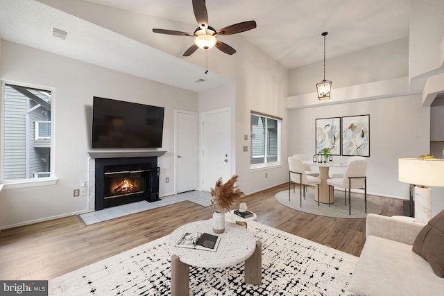 living room with ceiling fan and light hardwood / wood-style floors