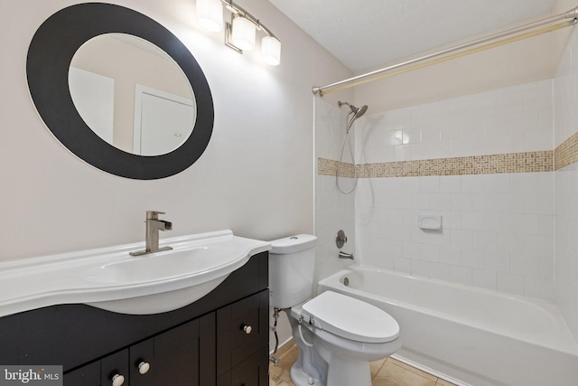 full bathroom featuring vanity, tiled shower / bath, tile patterned flooring, and toilet