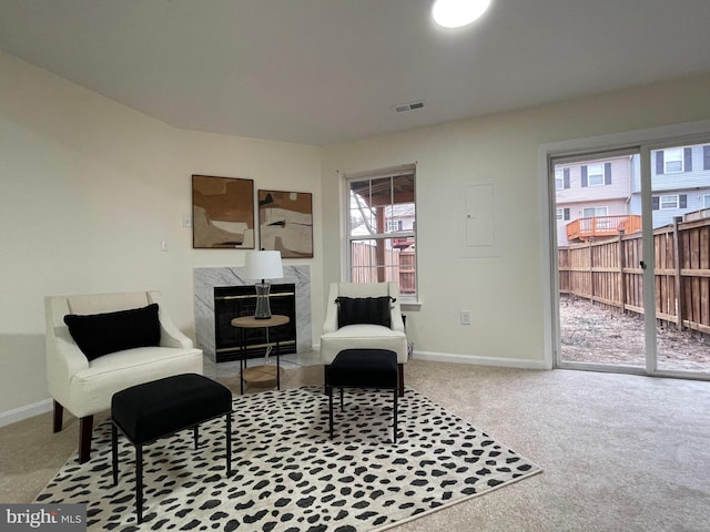 sitting room featuring carpet floors and a fireplace