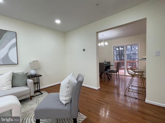 living room featuring dark wood-type flooring and a notable chandelier