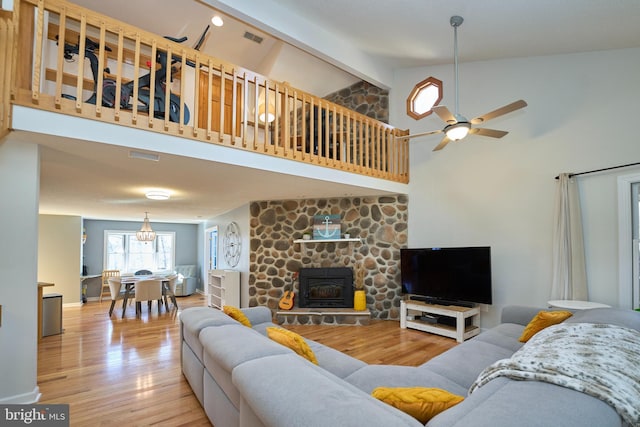 living room featuring visible vents, ceiling fan, light wood-style floors, high vaulted ceiling, and beam ceiling