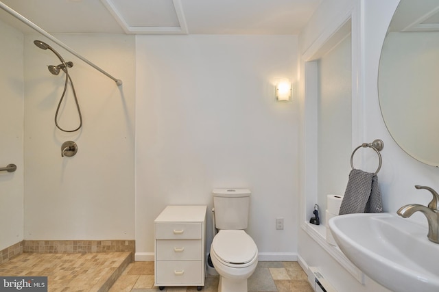 full bath featuring walk in shower, a sink, toilet, and baseboards