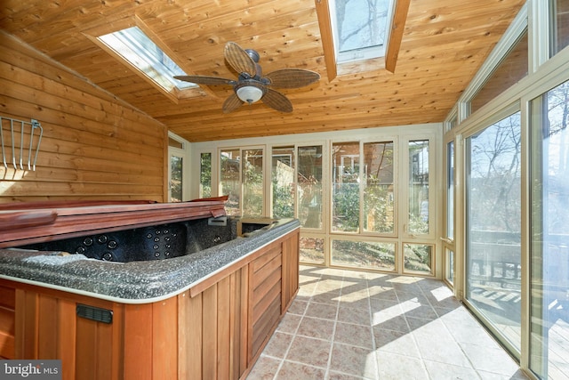 unfurnished sunroom featuring vaulted ceiling with skylight, wooden ceiling, and a jacuzzi