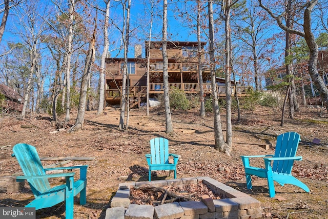 view of yard featuring an outdoor fire pit and a wooden deck