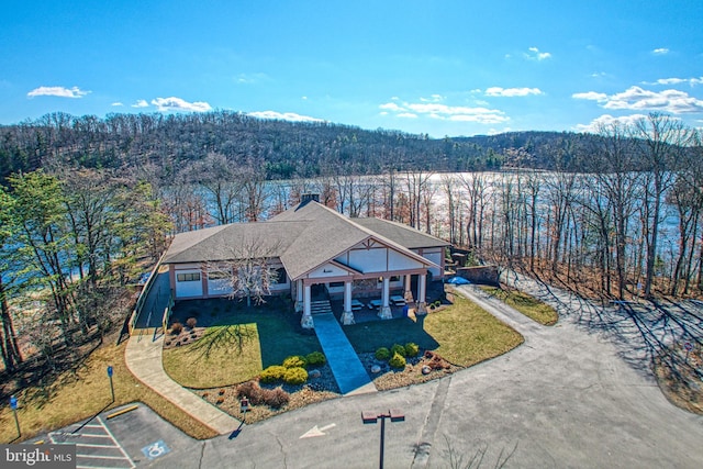 drone / aerial view featuring a view of trees