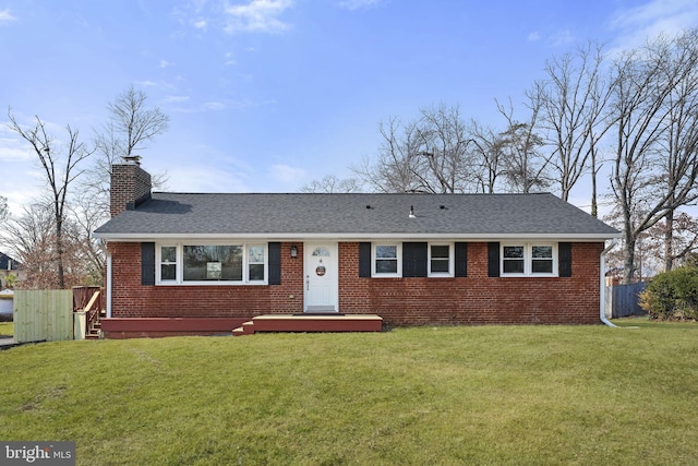 ranch-style home featuring a front yard, a chimney, fence, and brick siding