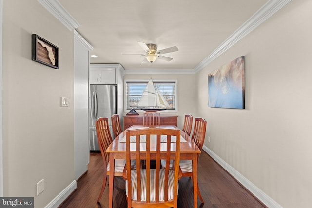 dining space with baseboards, ornamental molding, dark wood finished floors, and a ceiling fan