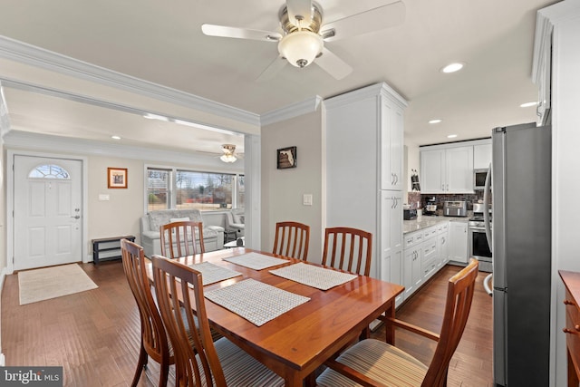 dining room featuring dark wood-style floors, ceiling fan, ornamental molding, and recessed lighting