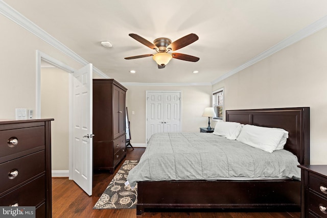 bedroom with dark wood-type flooring, a closet, ornamental molding, and baseboards