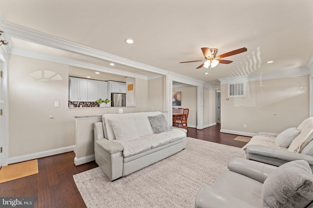 living area with dark wood-style flooring, crown molding, recessed lighting, visible vents, and baseboards