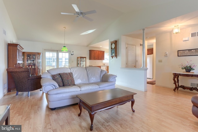 living room featuring high vaulted ceiling, ceiling fan, and light wood-type flooring