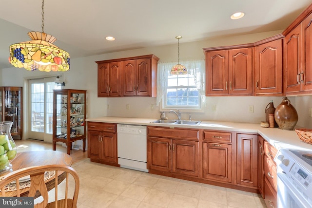 kitchen featuring range with electric cooktop, decorative light fixtures, dishwasher, and sink