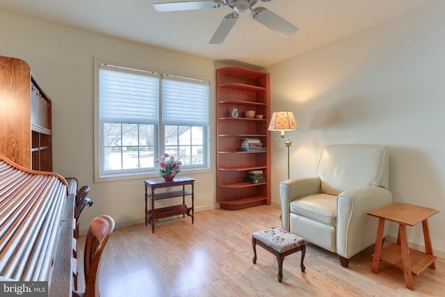 sitting room with light hardwood / wood-style floors and ceiling fan