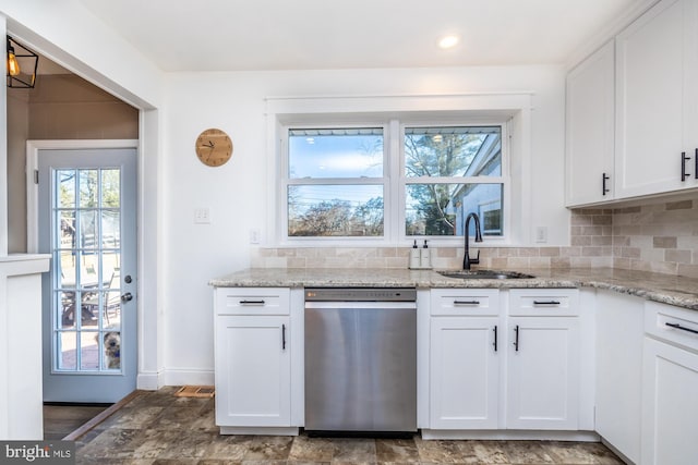 kitchen featuring sink, white cabinetry, light stone counters, dishwasher, and backsplash