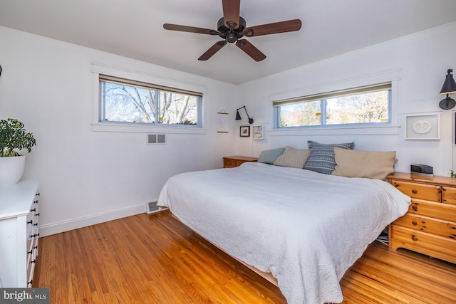 bedroom with hardwood / wood-style flooring and ceiling fan