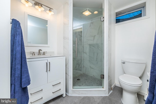 bathroom with vanity, toilet, and an enclosed shower