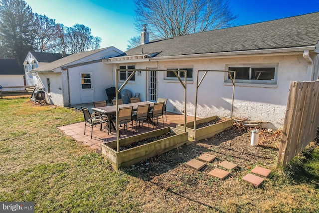 rear view of property featuring a patio area and a lawn