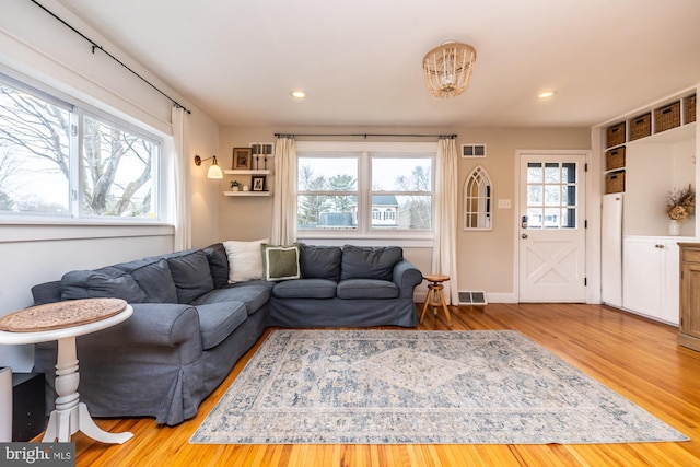 living room with plenty of natural light and light hardwood / wood-style floors