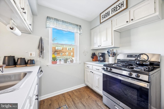 kitchen featuring white cabinetry, appliances with stainless steel finishes, dark wood-type flooring, and sink